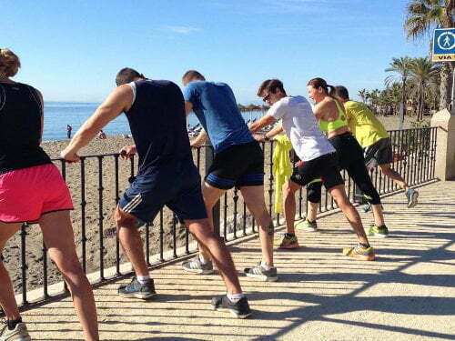 Runners stretching after training in Marbella